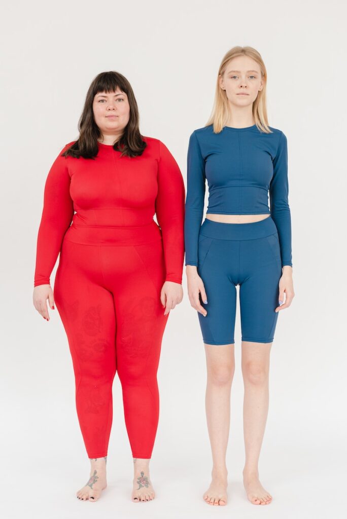 Content women in sportswear with different bodies after reducing weight