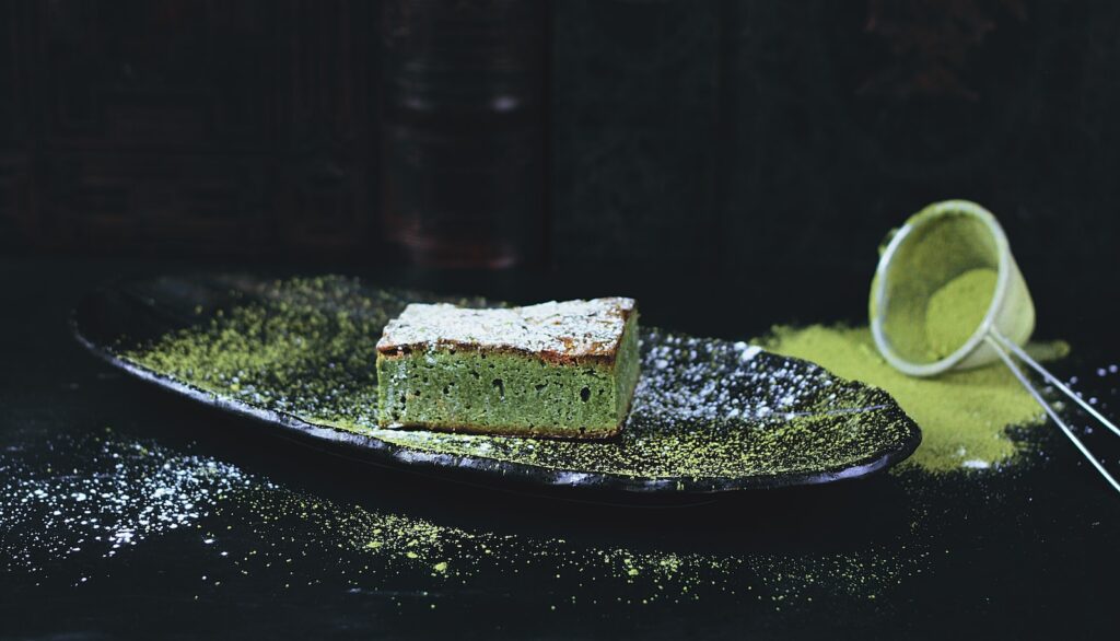 Incorporating matcha green tea into your daily routine - green and brown sponge cake on black oval plate